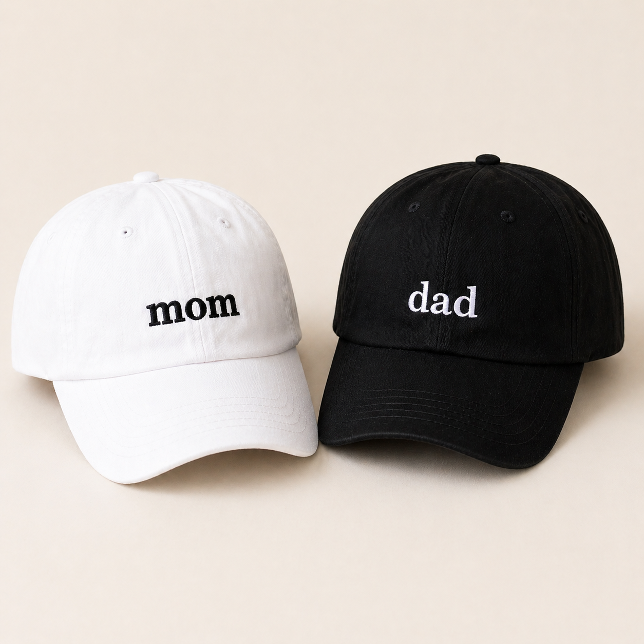 Mom and Dad matching embroidered hats in white and black.