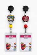 Teacher badge reels with colorful school charms and ID holders.